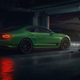 A photo of a green Bentley sports car in a garage.